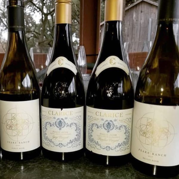 Four bottles of Pignetti's red and white wine, two Clarice Pinot Noir and two Peake Ranch.