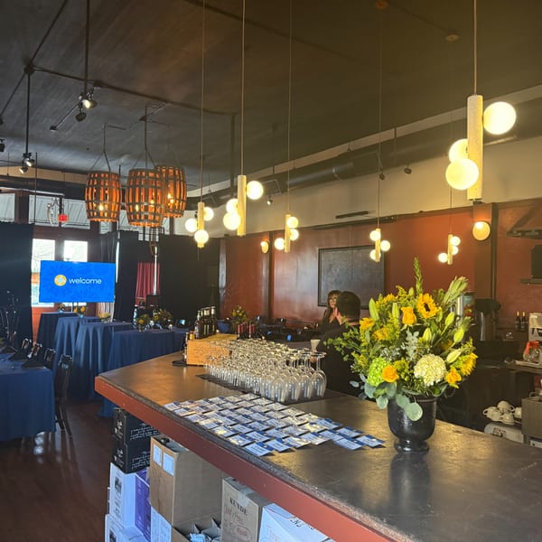 Pignetti's restaurant interior with a bar, wine glasses, name tags, and a large floral arrangement.